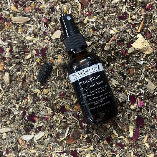 Protection mist on a bed of dried herbs and flowers